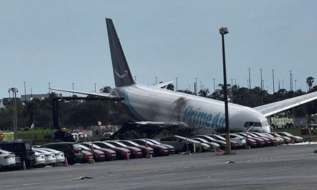 A view of the Amazon Prime Air cargo plane that airport officials said overran a runway at Miami, Florida, U.S., September 6, 2026, in this screengrab from a social media video. Rohan Ellis/via REUTERS  THIS IMAGE HAS BEEN SUPPLIED BY A THIRD PARTY. MANDATORY CREDIT. NO RESALES. NO ARCHIVES. THIS PICTURE WAS PROCESSED BY REUTERS TO ENHANCE QUALITY. AN UNPROCESSED VERSION HAS BEEN PROVIDED SEPARATELY.  VERIFICATION: - Date and location verified by metadata on original file - Fence, light poles and airfield layout matched archive imagery