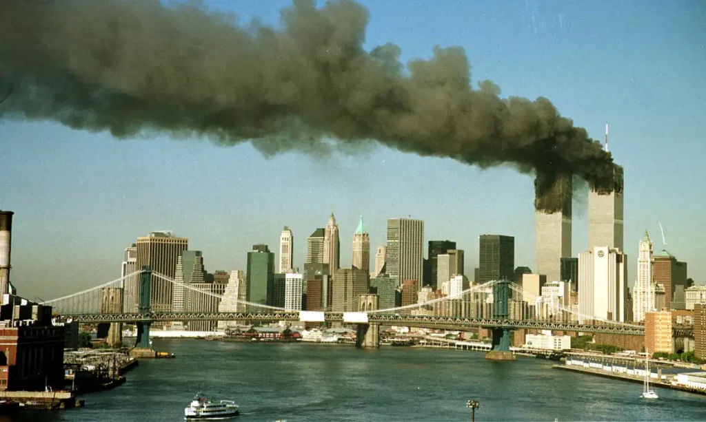 A September 11, 2001 file photo shows the towers of the World Trade Center pour smoke.