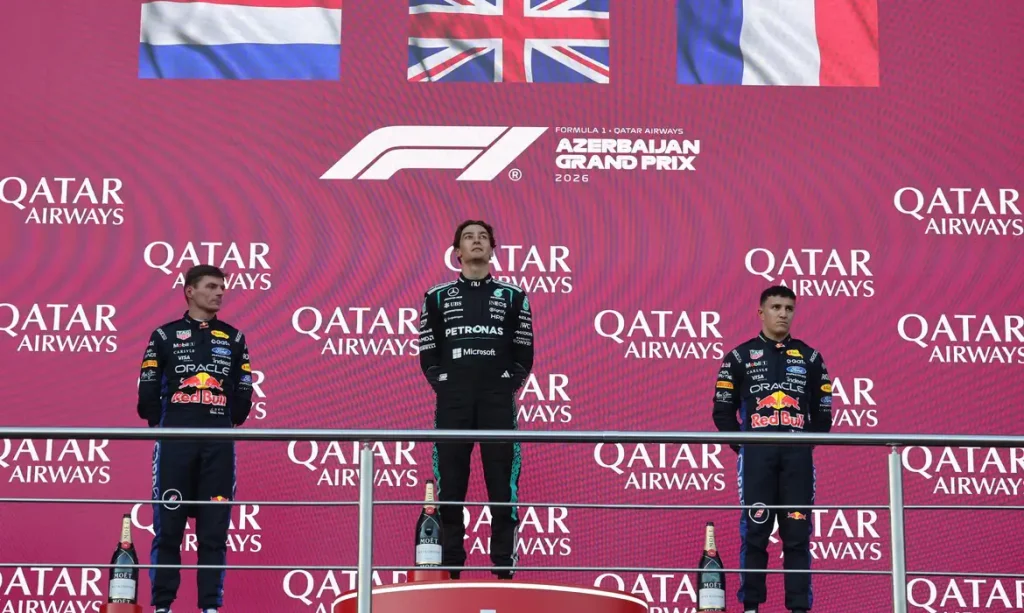 Formula One F1 - Azerbaijan Grand Prix - Baku City Circuit, Baku, Azerbaijan - September 26, 2026 Mercedes' George Russell celebrates on the podium after winning the race with second placed Red Bull's Max Verstappen and third placed Red Bull's Isack Hadjar REUTERS/Jakub Porzycki/Proibida Reprodução
