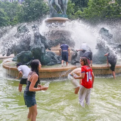 Young people cool off in the Fontaine de l'Observatoire fountain as temperatures rise in Paris and a heatwave hits a large part of France, June 18, 2026. REUTERS/Abdul Saboor