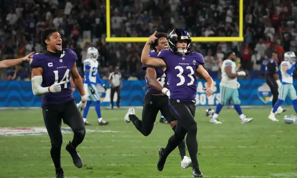 Sep 27, 2026; Rio De Janeiro, BRA;  Baltimore Ravens safety Kyle Hamilton (14) and kicker Tyler Loop (33) celebrate after Loop kicks the game winning field goal against the Dallas Cowboys during the game at Maracana Stadium.  Mandatory Credit: Kirby Lee-Imagn Images