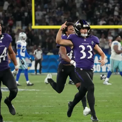 Sep 27, 2026; Rio De Janeiro, BRA; Baltimore Ravens safety Kyle Hamilton (14) and kicker Tyler Loop (33) celebrate after Loop kicks the game winning field goal against the Dallas Cowboys during the game at Maracana Stadium. Mandatory Credit: Kirby Lee-Imagn Images